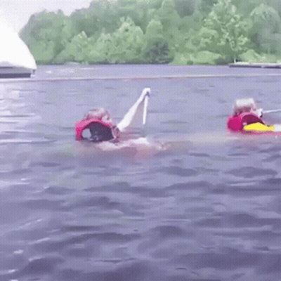 A Couple Of People Are Floating In The Water . GIF