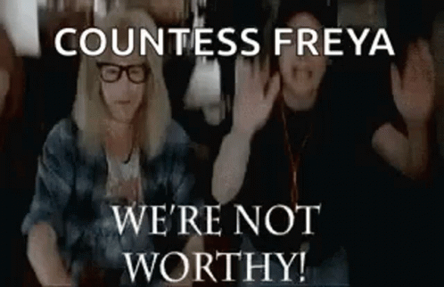 A Couple Of People Are Sitting Next To Each Other And Waving Their Hands . GIF