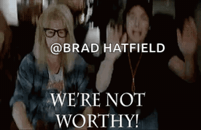 A Couple Of People Sitting Next To Each Other With The Words We 'Re Not Worthy Written On The Bottom . GIF