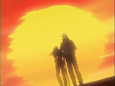 A Couple Of People Standing In Front Of A Large Yellow And Red Sun GIF