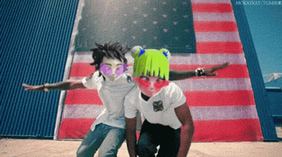A Couple Of People Standing In Front Of An American Flag With Their Arms Outstretched GIF