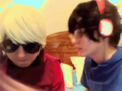 A Couple Of People Standing Next To Each Other With One Wearing Sunglasses GIF