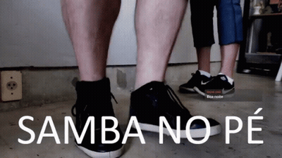 A Couple Of People Standing Next To Each Other With Samba No Pe Written On The Bottom GIF