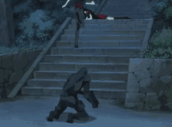 A Couple Of People Standing On A Set Of Stairs With A White Car In The Foreground GIF