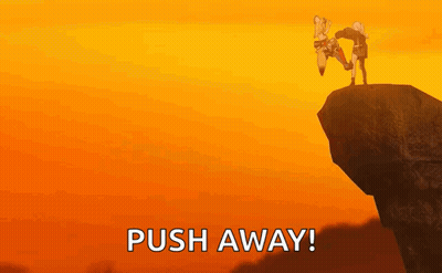 A Couple Of People Standing On Top Of A Cliff . GIF