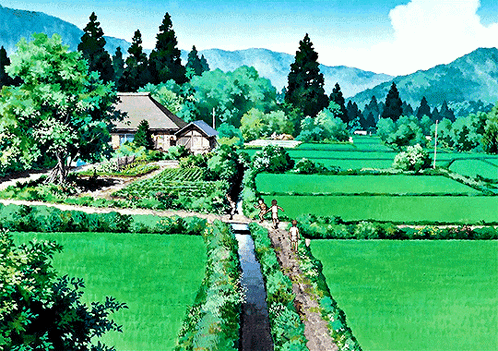 A Couple Of People Walking Through A Lush Green Field With Mountains In The Background GIF