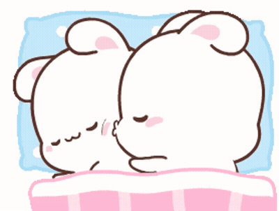A Couple Of Rabbits Are Laying On A Bed And One Is Kissing The Other GIF