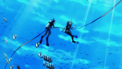 A Couple Of Scuba Divers Are Swimming In The Ocean With Fish GIF