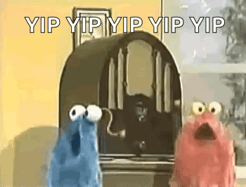A Couple Of Sesame Street Characters Standing Next To A Radio . GIF