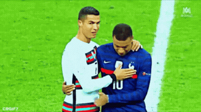 A Couple Of Soccer Players Are Hugging Each Other On A Field . GIF