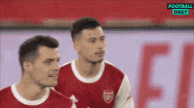 A Couple Of Soccer Players Are Standing Next To Each Other On A Field With A Football Daily Logo In The Background . GIF