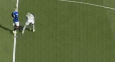 A Couple Of Soccer Players Are Standing On A Field Talking To Each Other . GIF