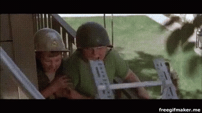 A Couple Of Soldiers Standing Next To Each Other On A Staircase . GIF