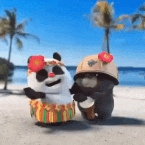 A Couple Of Stuffed Animals Are Dancing On A Beach . One Of The Animals Is Wearing A Hula Skirt . GIF