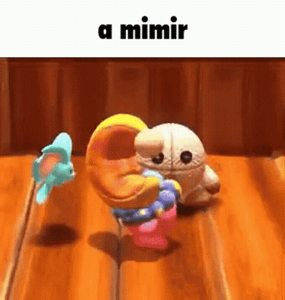 A Couple Of Stuffed Animals Are Dancing On A Wooden Table With A Caption That Says A Mimir . GIF