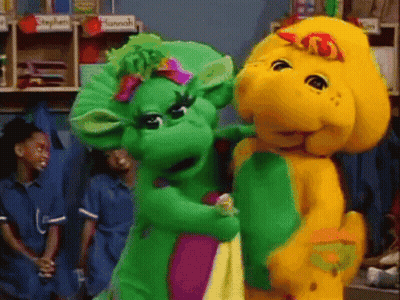 A Couple Of Stuffed Animals Are Standing Next To Each Other In A Room With A Sign That Says Stephen On It GIF