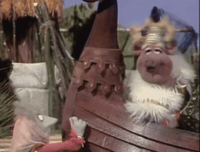 A Couple Of Stuffed Animals Standing Next To Each Other With One Wearing A Crown GIF