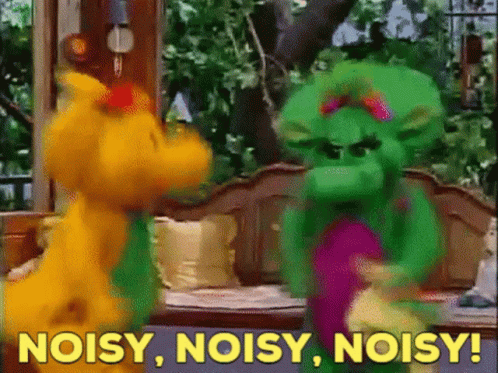 A Couple Of Stuffed Animals Standing Next To Each Other With The Words Noisy Noisy Noisy In The Background GIF