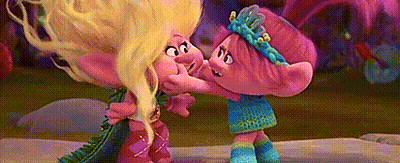 A Couple Of Trolls Standing Next To Each Other And Hugging . GIF