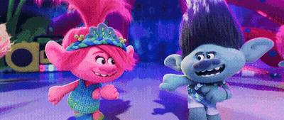 A Couple Of Trolls Standing Next To Each Other On A Dance Floor . GIF