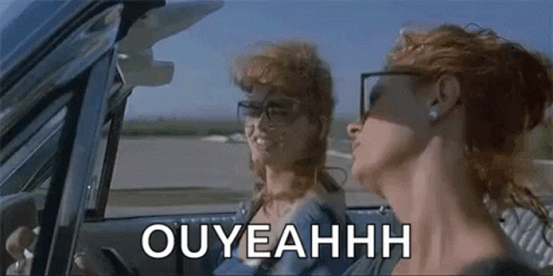 A Couple Of Women Are Sitting In A Car And One Of Them Is Wearing Glasses . GIF