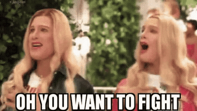A Couple Of Women Are Standing Next To Each Other And One Of Them Is Screaming . GIF