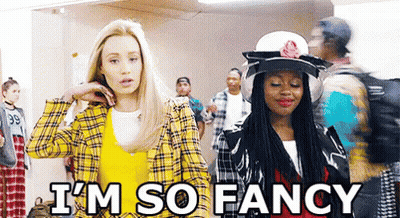 A Couple Of Women Are Standing Next To Each Other In A Hallway . GIF