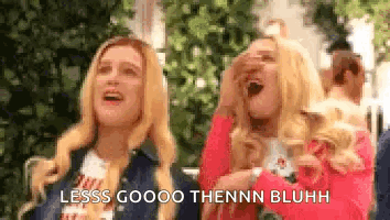 A Couple Of Women Standing Next To Each Other With Their Mouths Open And Laughing . GIF