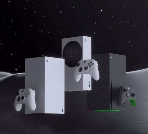 A Couple Of Xbox Consoles Sitting Next To Each Other On A Table GIF