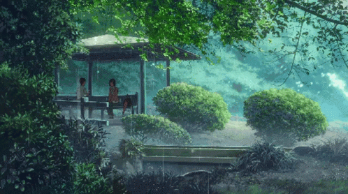 A Couple Sits Under A Gazebo In The Rain GIF