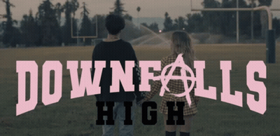 A Couple Standing In A Field With The Words Downfalls High Above Them GIF