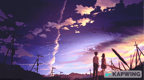 A Couple Standing In Front Of A Sunset With Kapwing In The Bottom Right Corner GIF