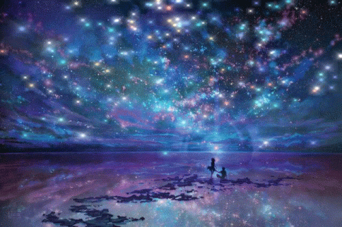 A Couple Standing On A Beach Looking Up At The Stars GIF