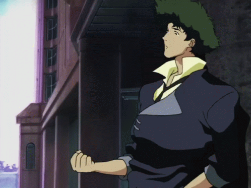 A Cowboy Bebop Character Stands In Front Of A Building With His Fist In The Air GIF