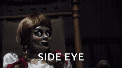 A Creepy Doll Is Sitting In A Chair With The Words `` Side Eye '' Written Below Her . GIF