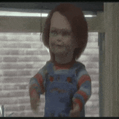 A Creepy Doll Is Standing In Front Of A Window . GIF