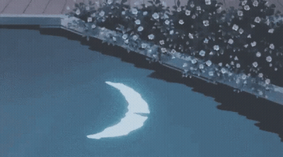 A Crescent Moon Is Floating In A Swimming Pool At Night . GIF