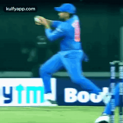 A Cricket Player In A Blue Uniform Is Playing A Game Of Cricket . GIF