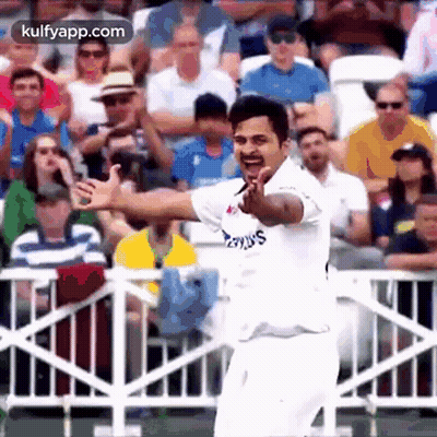 A Cricket Player Is Giving A Thumbs Up In Front Of A Crowd . GIF