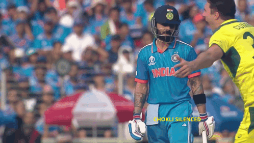 A Cricket Player Wearing A Blue Jersey That Says India On It GIF
