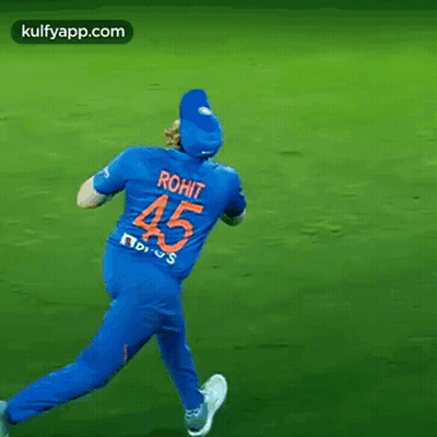 A Cricket Player Wearing A Blue Jersey With The Number 45 On The Back Is Running On A Field . GIF