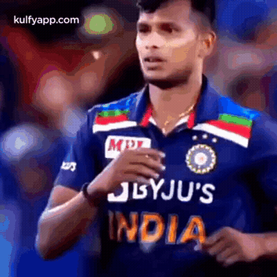 A Cricket Player Wearing A Blue Jersey With The Word India On It . GIF
