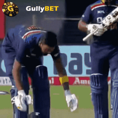 A Cricket Player Wearing A Blue Shirt With The Word Gullybet On The Bottom GIF
