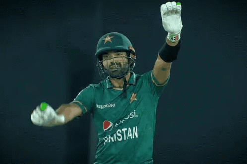 A Cricket Player Wearing A Pepsi Shirt Holds His Arms Up In The Air GIF