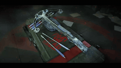 A Crossbow Is Sitting On Top Of A Box That Says " Fight The Dead " GIF