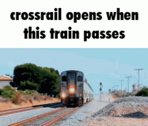 A Crossrail Opens When This Train Passes With A Train On The Tracks GIF