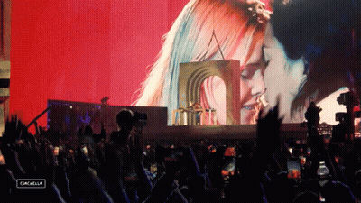 A Crowd At A Concert With A Sign That Says Cancella GIF