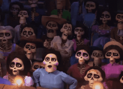 A Crowd Of Cartoon Skeletons Are Sitting In A Theater GIF