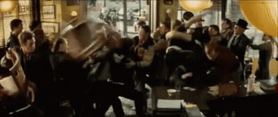 A Crowd Of People Are Gathered In A Room With A Sign That Says " Check Out " GIF