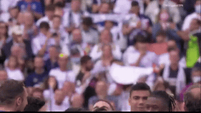 A Crowd Of People Are Gathered In A Stadium Watching A Basketball Game . GIF
